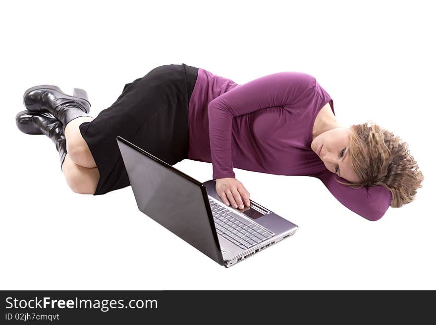 A woman in purple is laying by her computer with her hand on her computer. A woman in purple is laying by her computer with her hand on her computer.