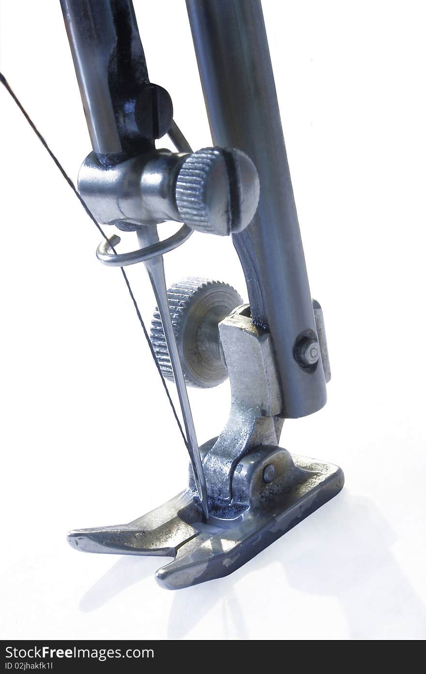 Part of the mechanism of the sewing machine, needle and thread. Part of the mechanism of the sewing machine, needle and thread