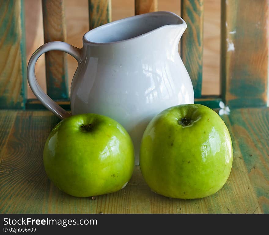 Two green apples and white  jug. Two green apples and white  jug