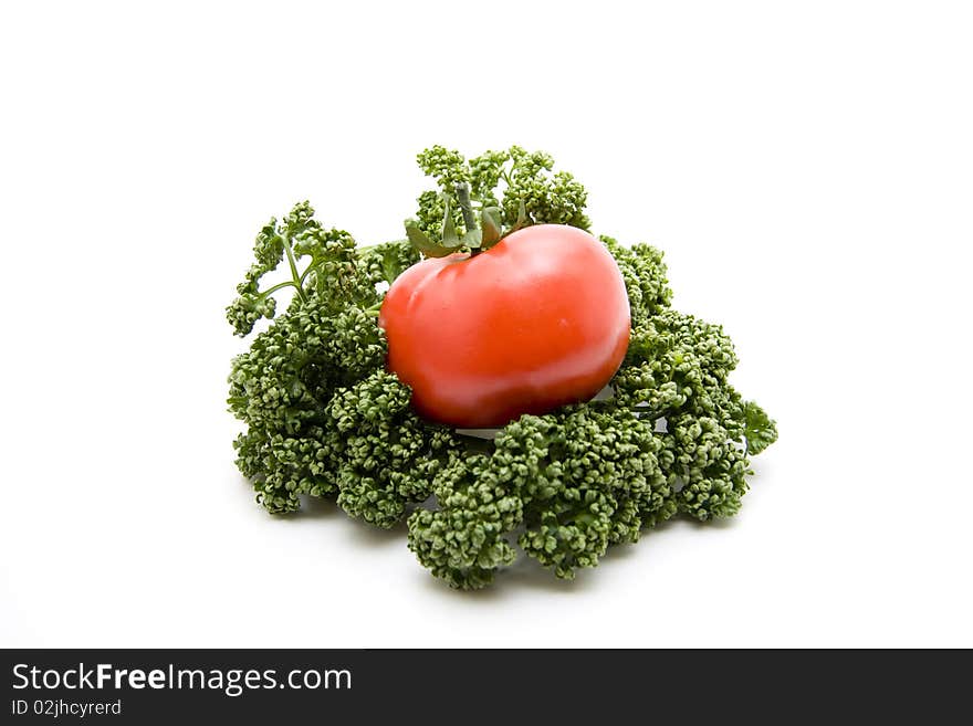 Tomato with parsley onto white background