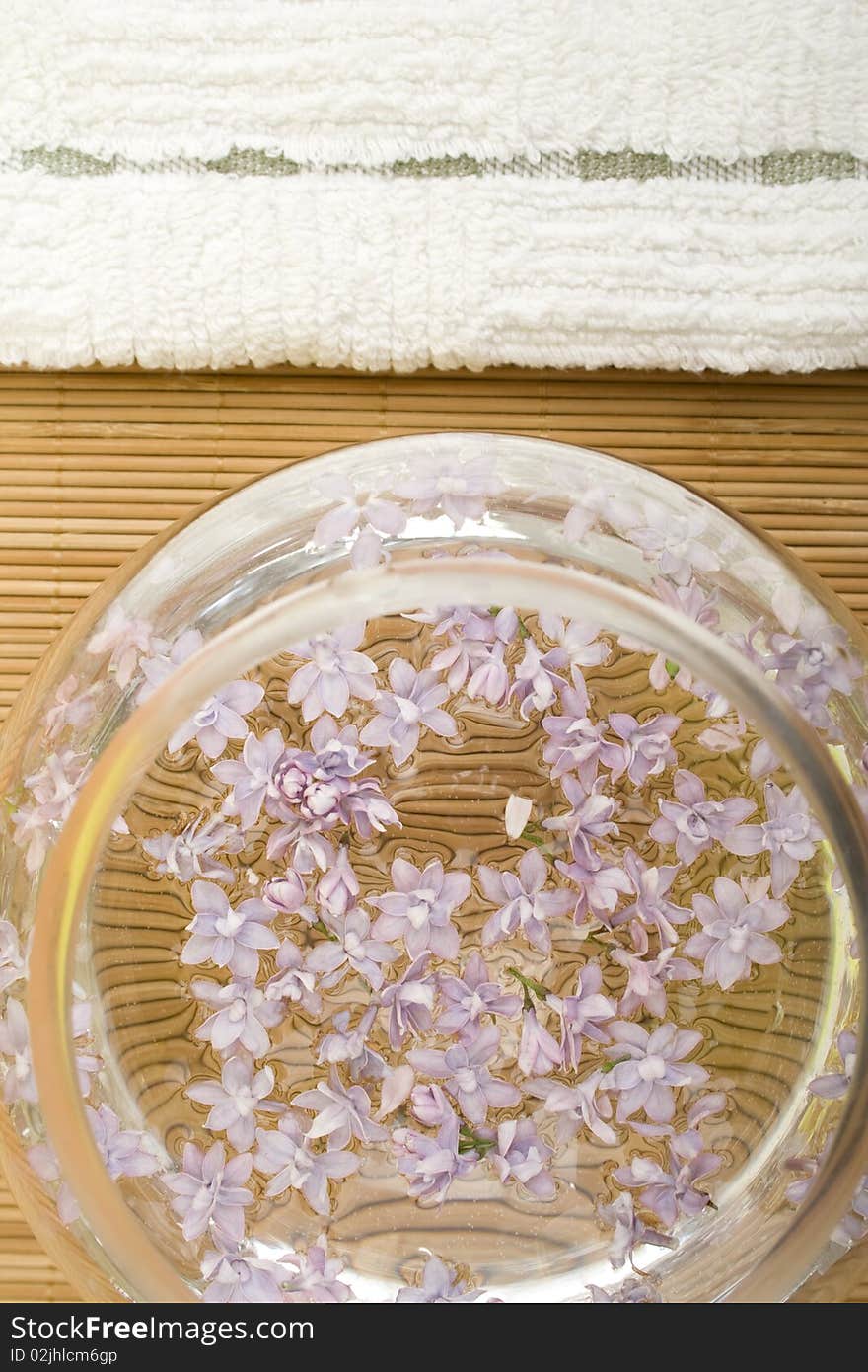 Flowers lilac to lie on the water in a glass dish towel next. Flowers lilac to lie on the water in a glass dish towel next