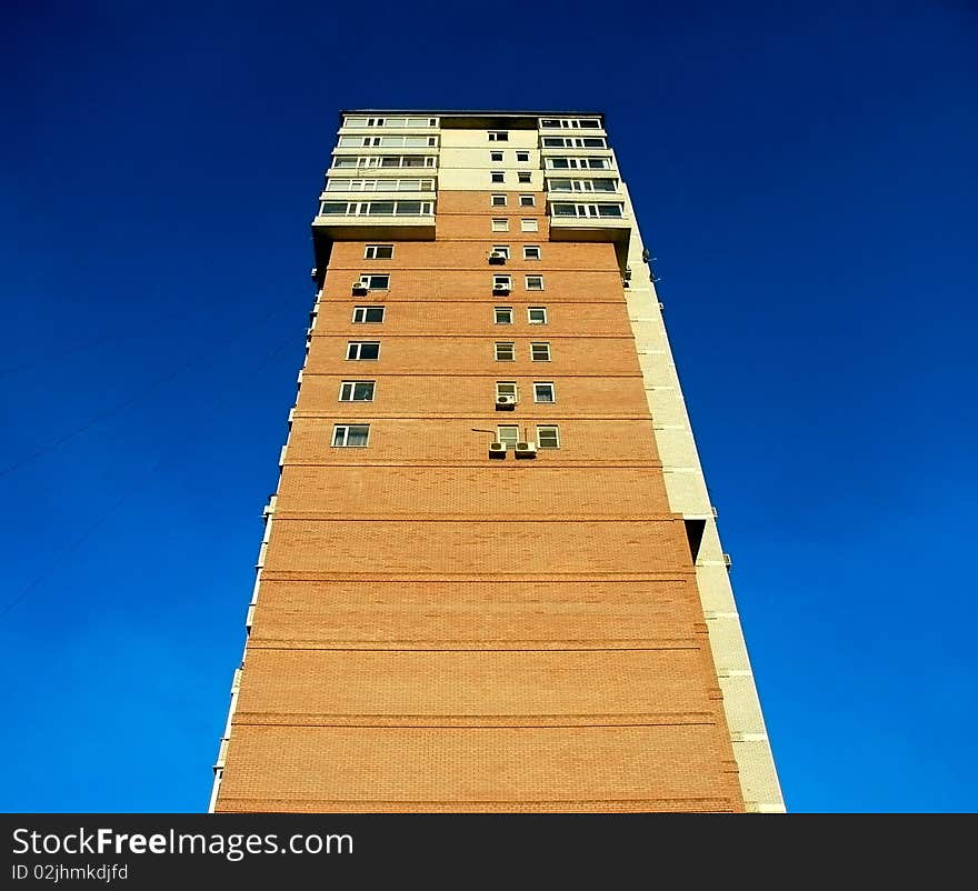 High building from a red brick against the sky. High building from a red brick against the sky