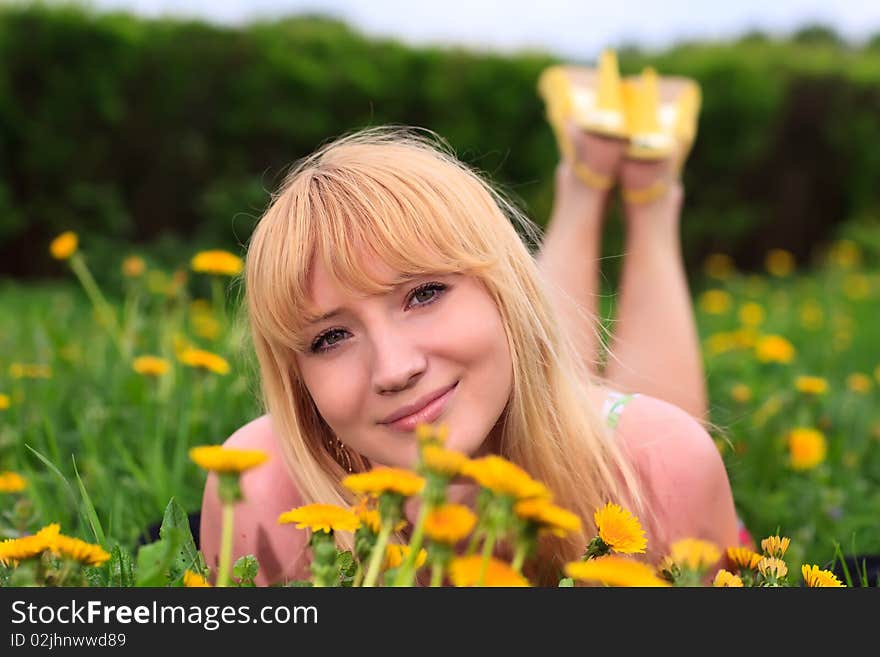 Young woman laying down in meadow