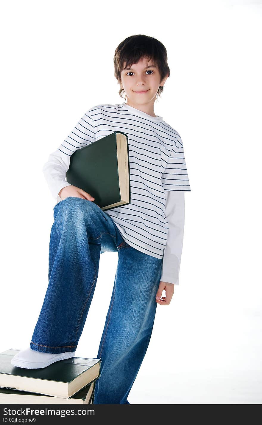 Cute little boy near the stack of big books on white background