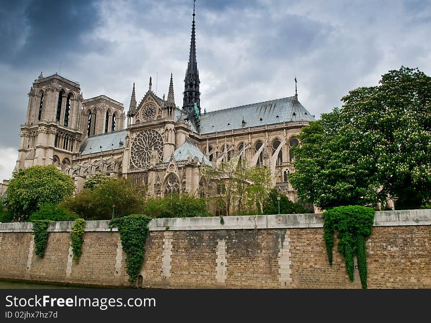 Notre Dame Cathedral in Paris, France against a stormy spring sky. Notre Dame Cathedral in Paris, France against a stormy spring sky.