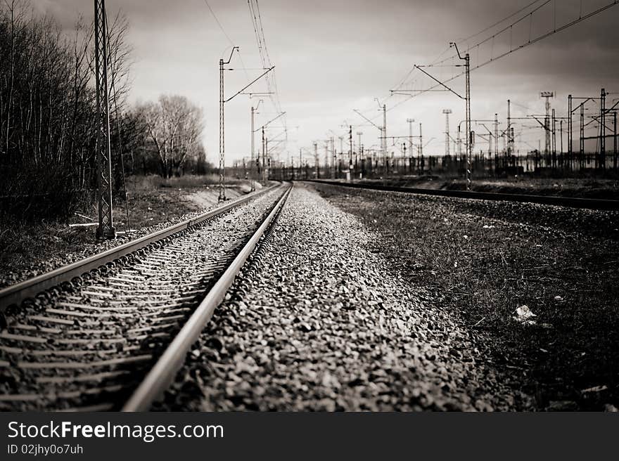 Single railroad track with industrial background