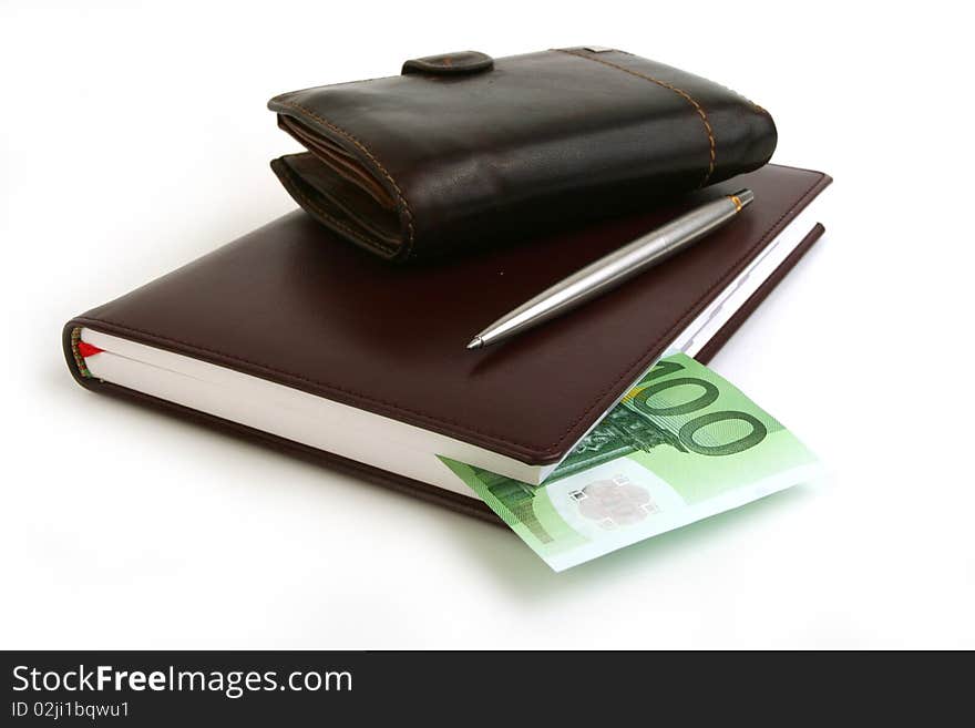 Banknote 100 euro in brown notebook, purse and pen on white background. Banknote 100 euro in brown notebook, purse and pen on white background