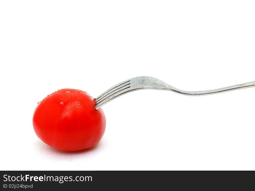 Picture of isolated tomato and fork with white background.