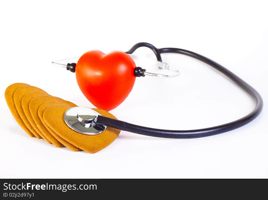 Red hart wits a stethoscope  examining brown ginger bred hearts. Red hart wits a stethoscope  examining brown ginger bred hearts