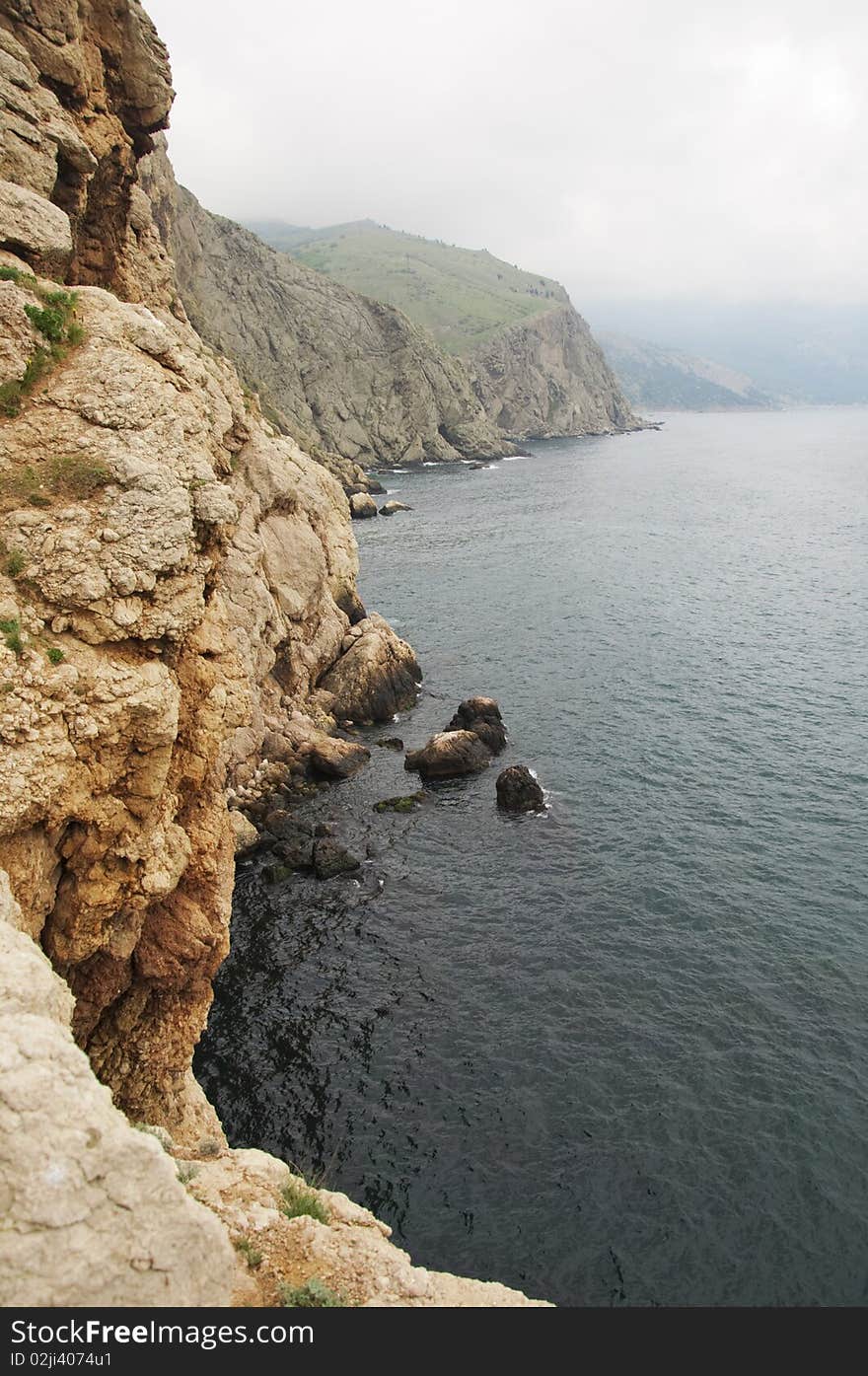 Mountain on the sea in the fog