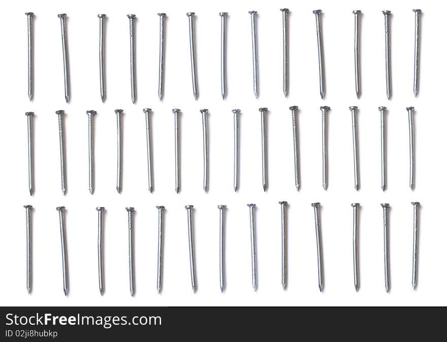 Three rows of steel nails isolated on white