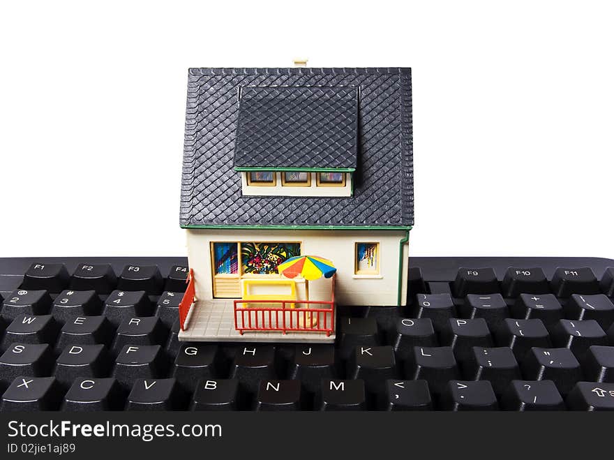 Model house with keyboard on white background