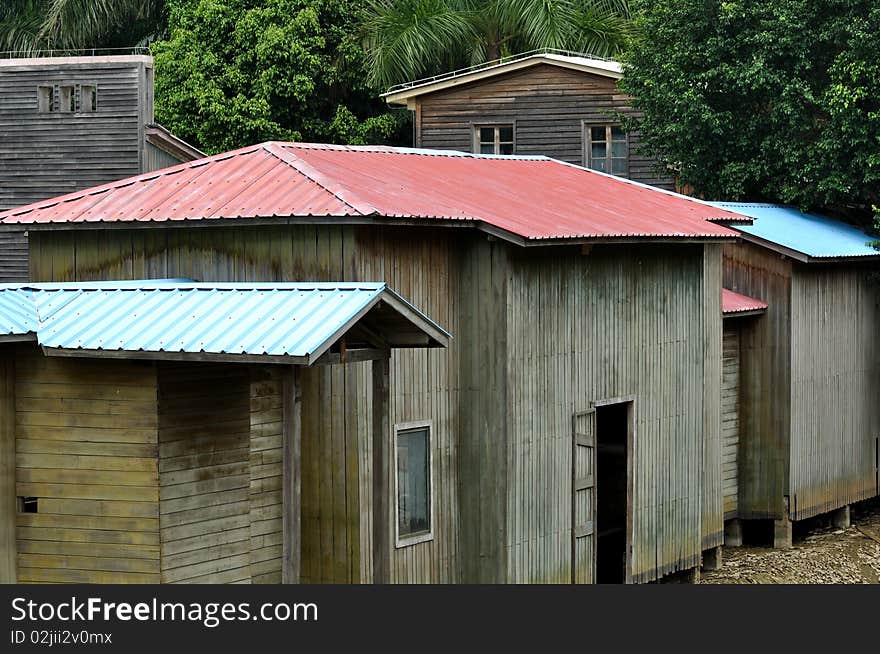 Wooden cabins with almost consistant shape have colorful roof under green plant, shown as consistant, harmonious and rhythm. Wooden cabins with almost consistant shape have colorful roof under green plant, shown as consistant, harmonious and rhythm.