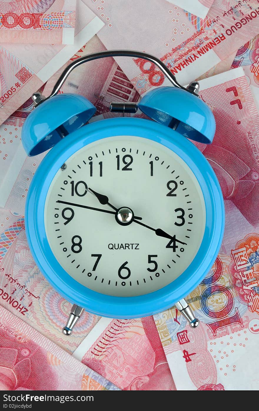 A blue timekeeper with a lot of money bills, means time is money or time value and cost.