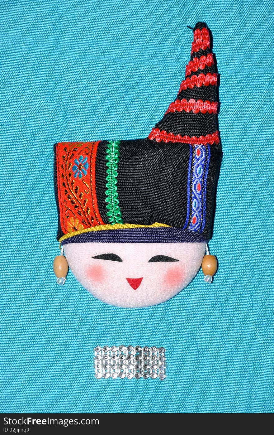 Finery embroidery doll of Chinese minority Chuang's tradtional style. The raiment and hat for men in feast day. Finery embroidery doll of Chinese minority Chuang's tradtional style. The raiment and hat for men in feast day.