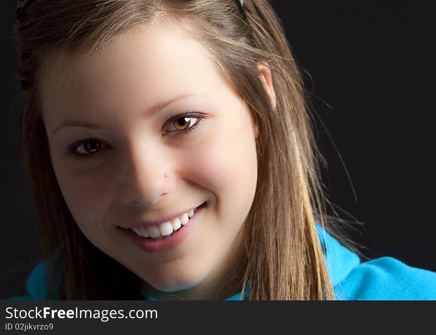 An attractive young blond woman against a black background. An attractive young blond woman against a black background