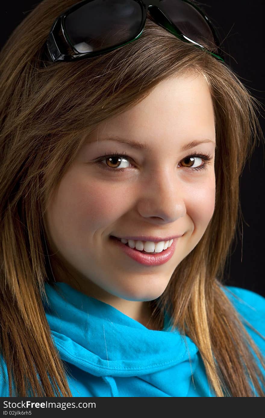 An attractive young blond woman against a black background. An attractive young blond woman against a black background