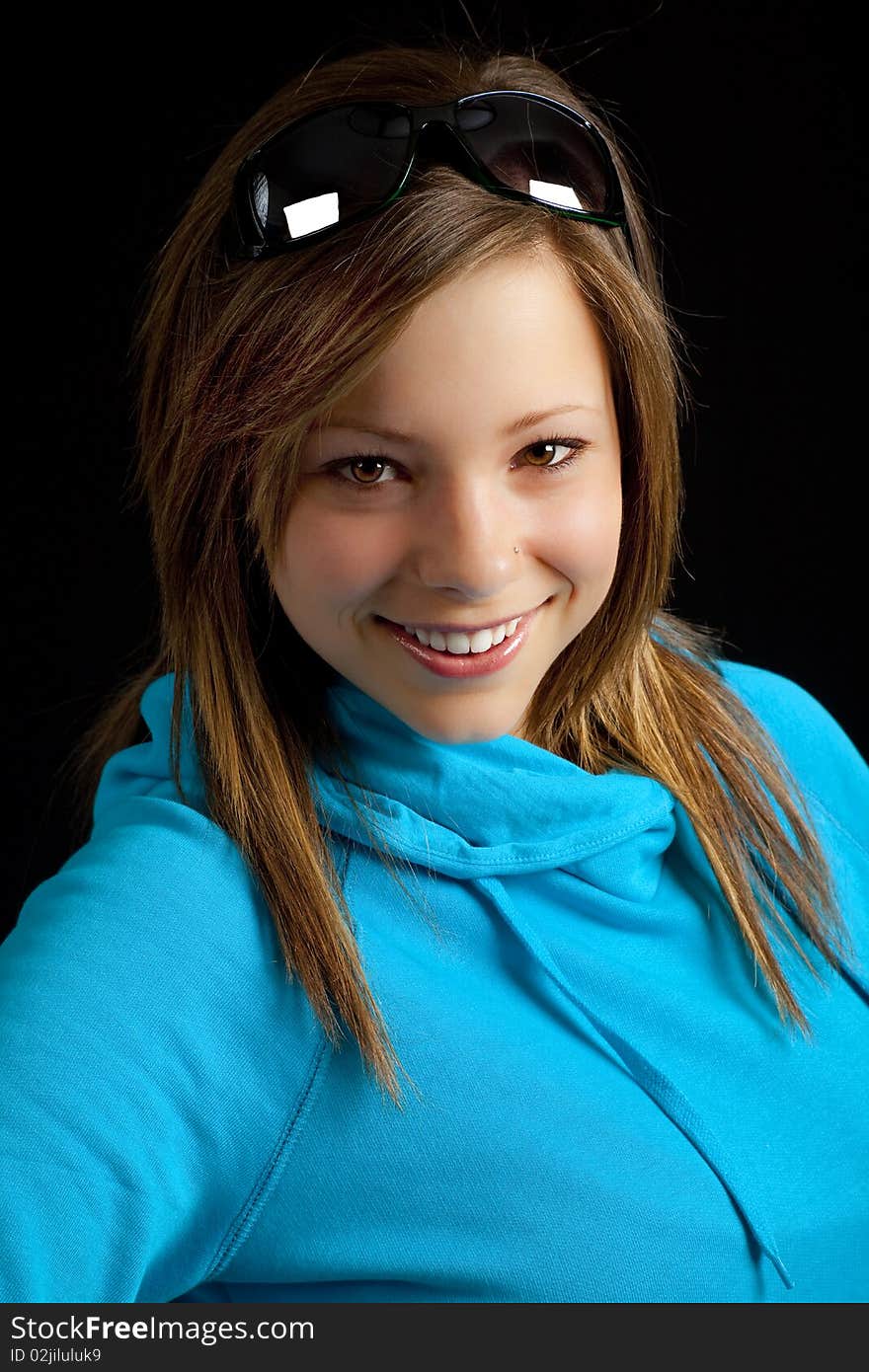 An attractive young blond woman against a black background. An attractive young blond woman against a black background