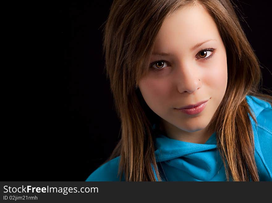 An attractive young blond woman against a black background. An attractive young blond woman against a black background