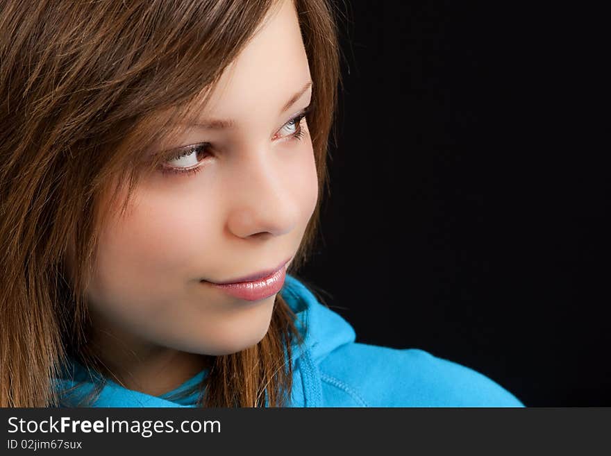 An attractive young blond woman against a black background. An attractive young blond woman against a black background