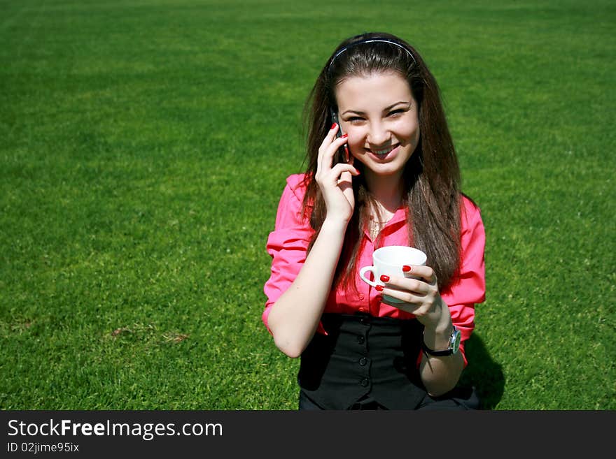 Young businesswoman drinking tea and talking