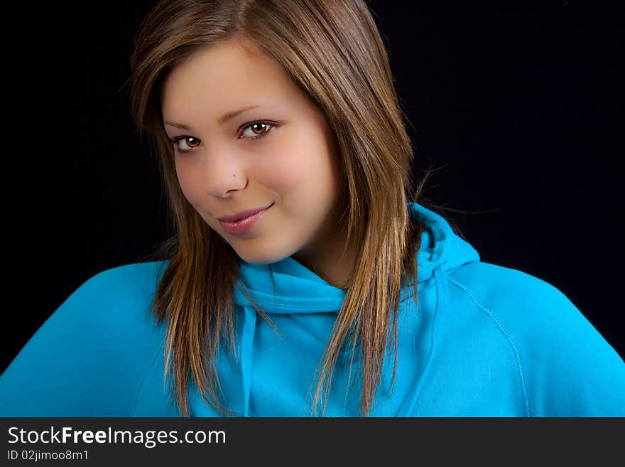 An attractive young blond woman against a black background. An attractive young blond woman against a black background