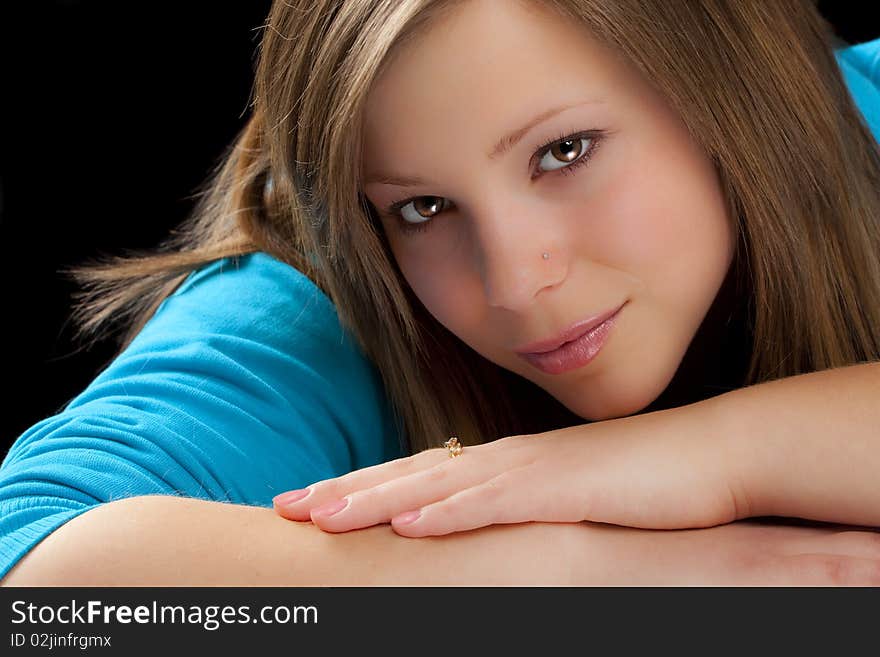 An attractive young blond woman against a black background. An attractive young blond woman against a black background