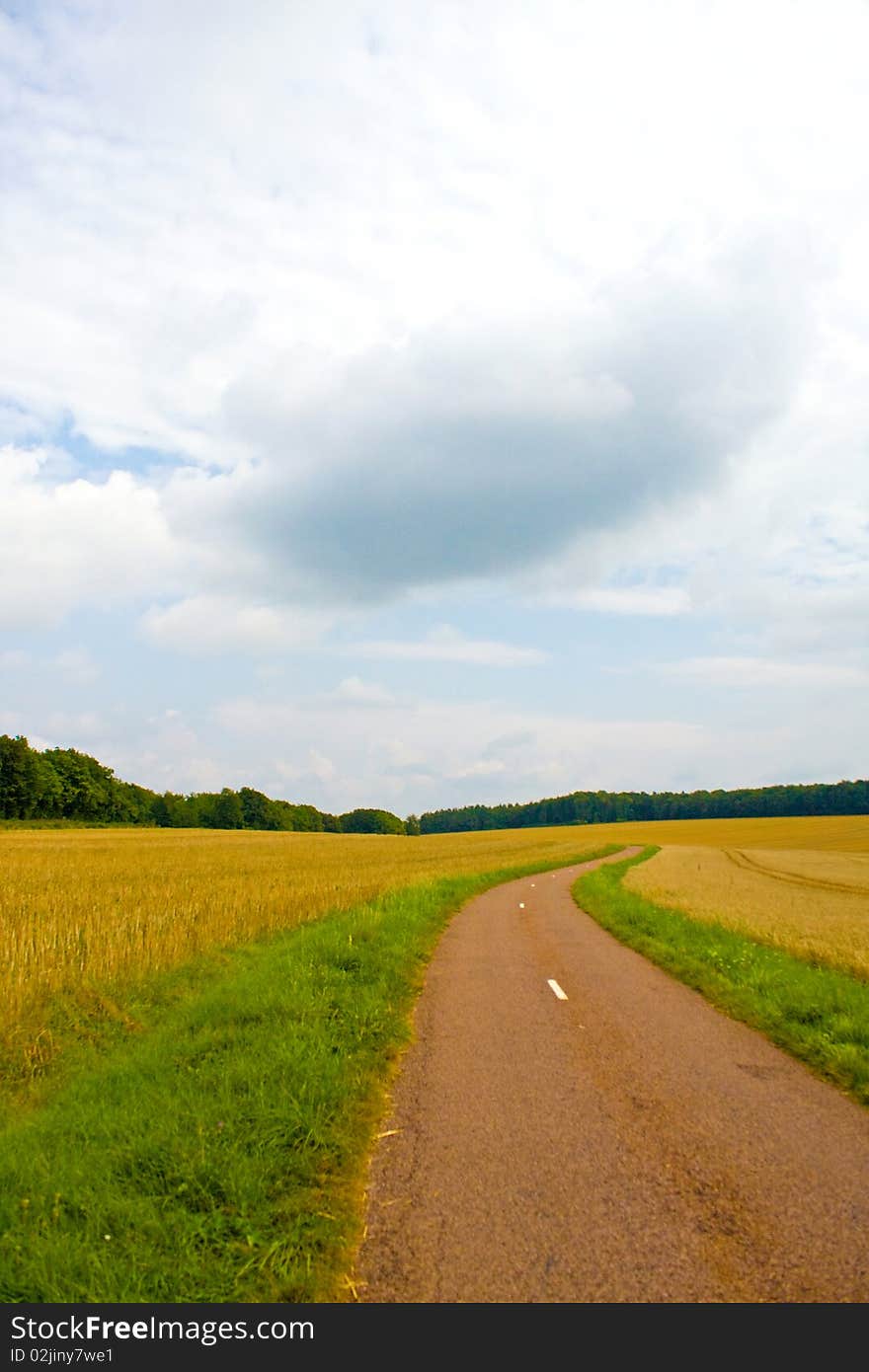 Highway in landscape with cloudy sky