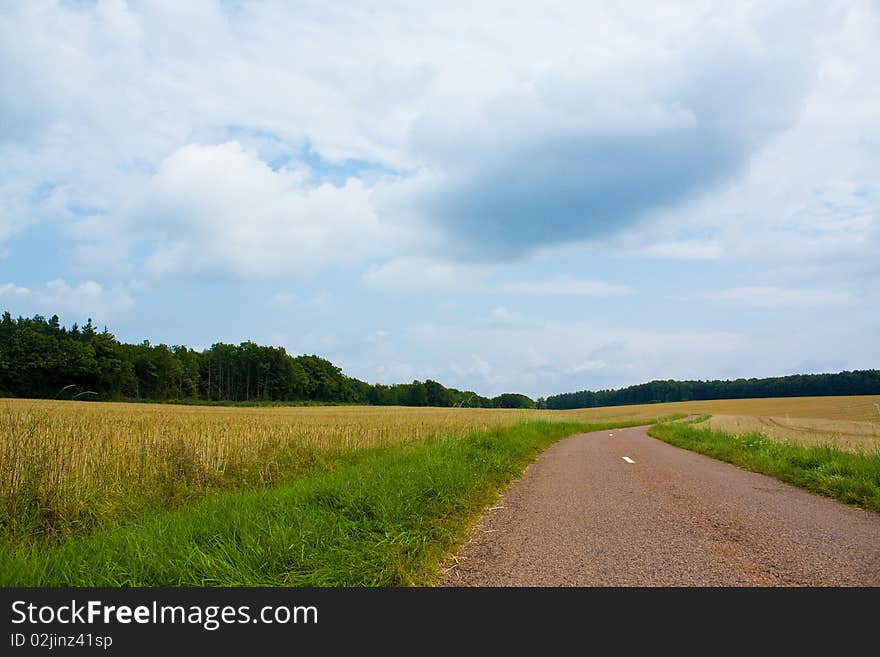 Highway in landscape with cloudy sky