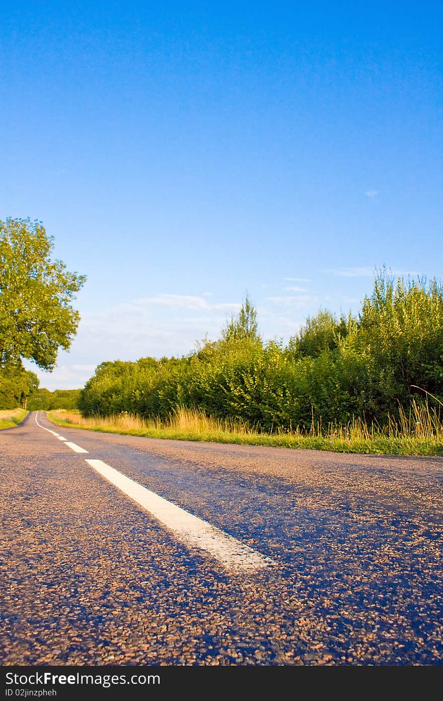 Highway in landscape with cloudy sky