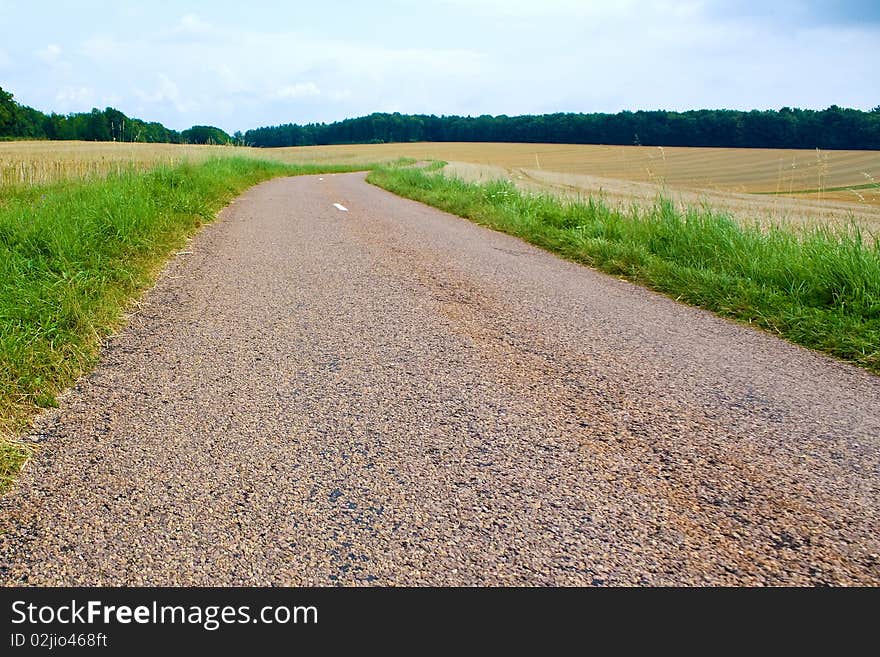 Highway in landscape with cloudy sky