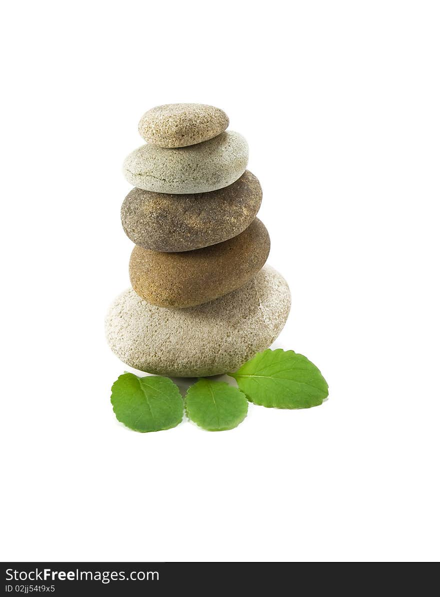 Stack of pebbles and leaf on white background. Stack of pebbles and leaf on white background