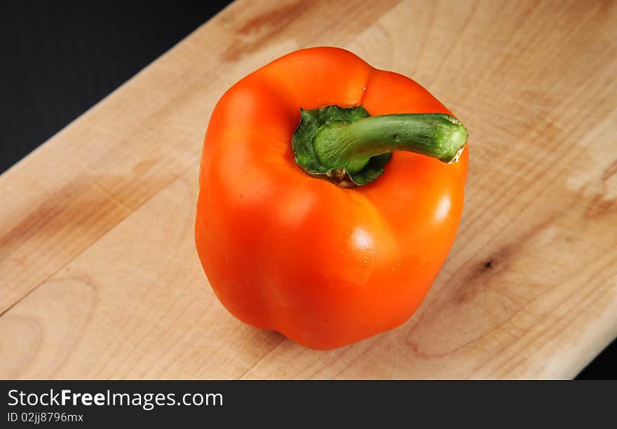 Orange Bell Pepper on a cutting board