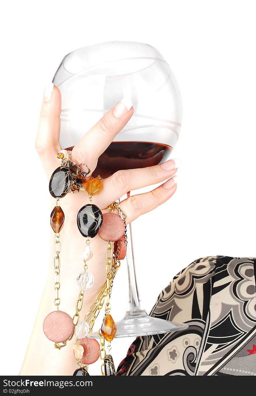 Woman arm with glass of wine.