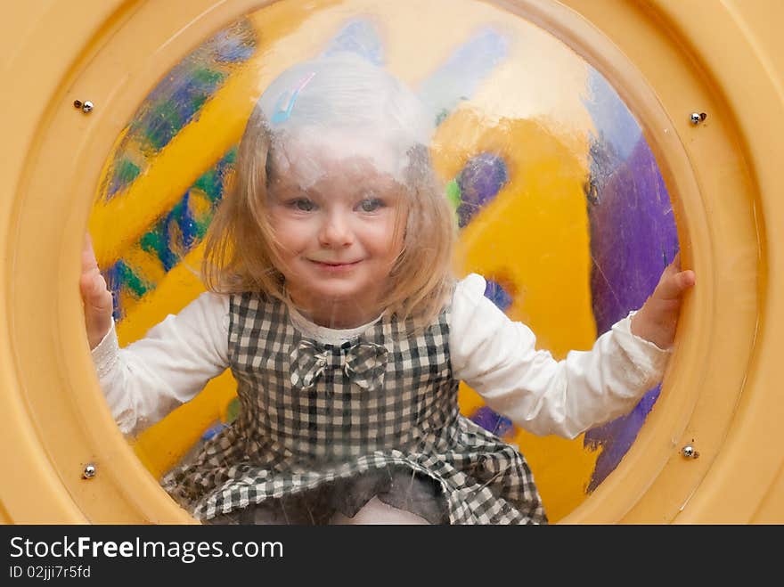 Smiling girl in porthole. Outdoor shot. Smiling girl in porthole. Outdoor shot