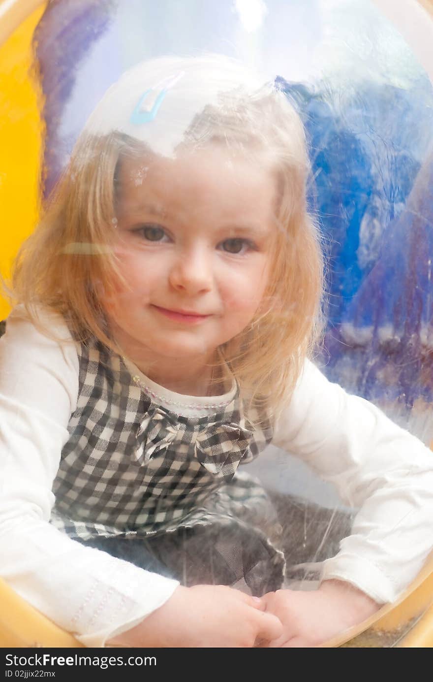 Smiling girl in porthole. Outdoor shot