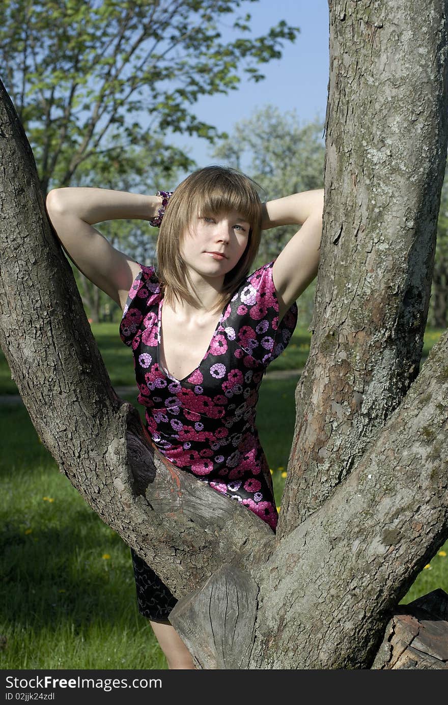 Young beautiful model between trees. Young beautiful model between trees