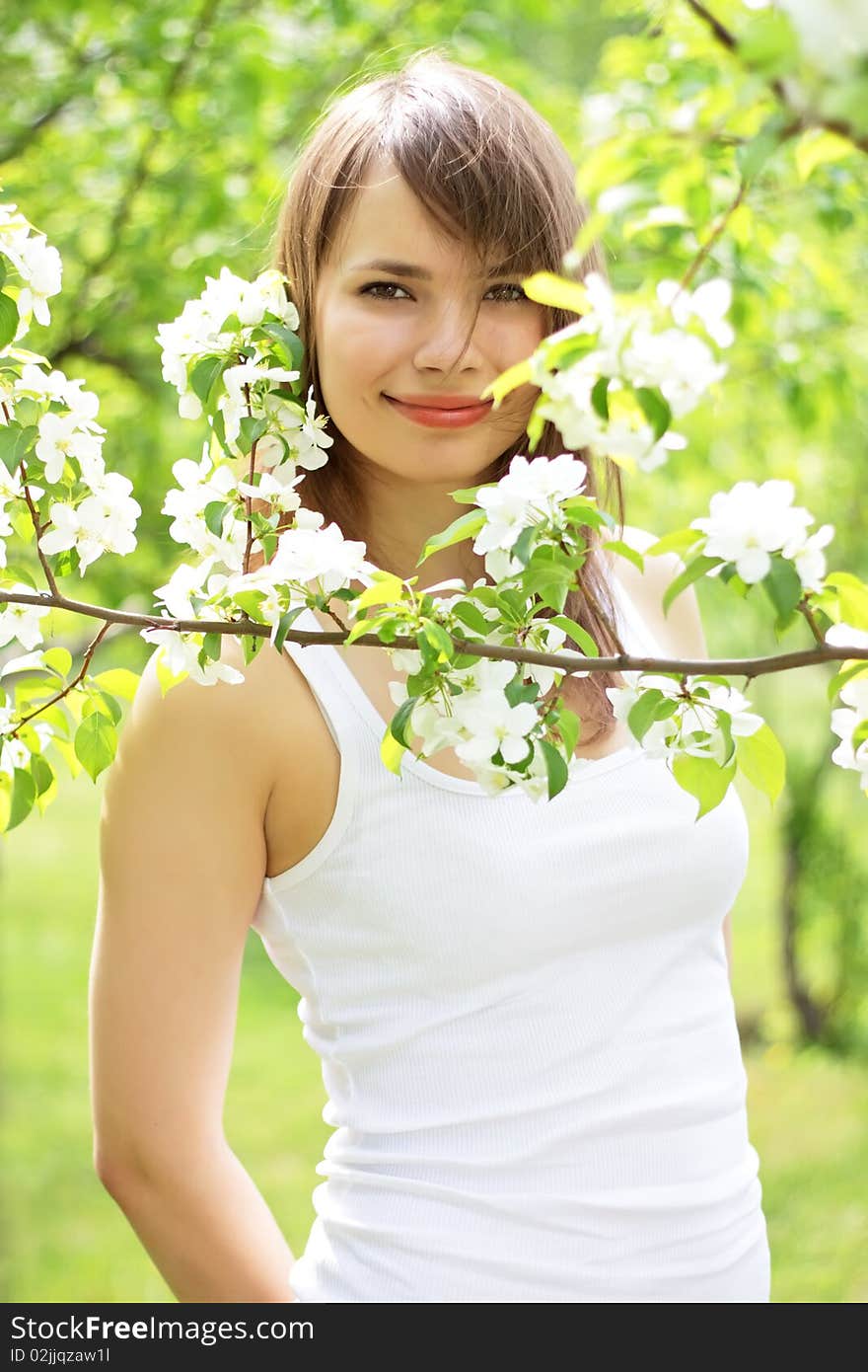 Beautiful girl about to apple tree