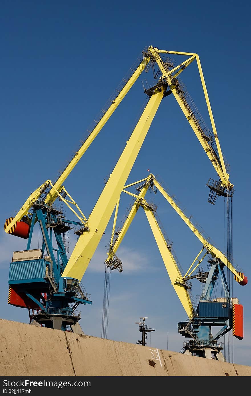 Huge industrial cranes working at the commercial dock. Huge industrial cranes working at the commercial dock