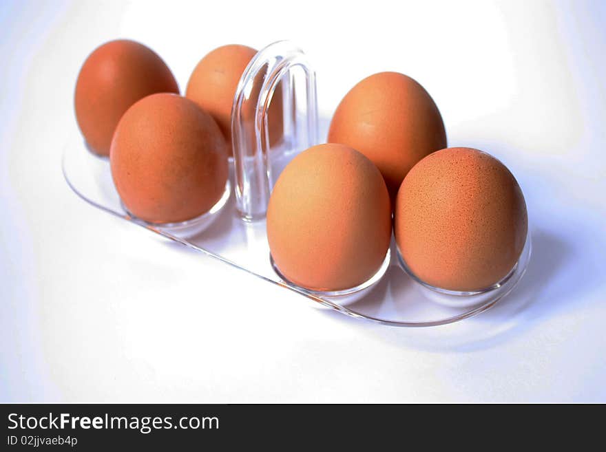 Brown eggs in tray on white background