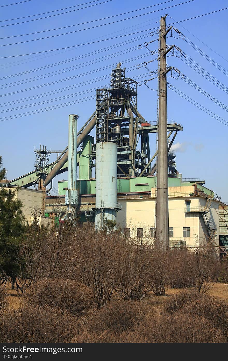 Steelworks and tree in the sky