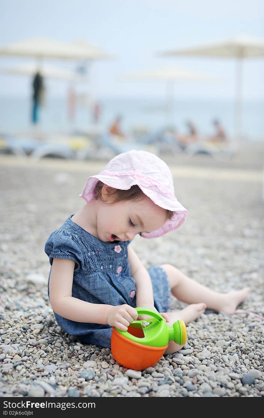 Adorable toddler girl plaiyng on a beach