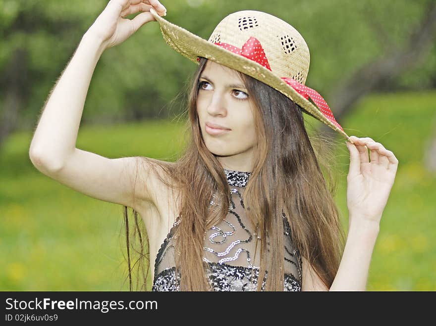 Girl with long hair in straw hat