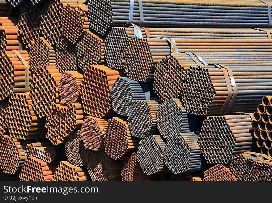 The big bundles of steel bars pile up in the construction site. The big bundles of steel bars pile up in the construction site.