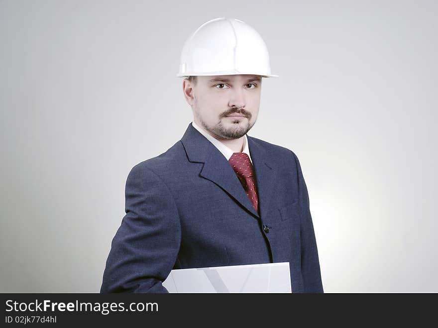 A man in a building helmet with a folder