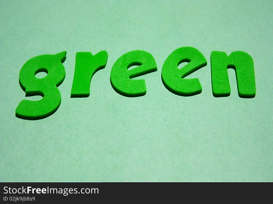 Green foam letter word on green background