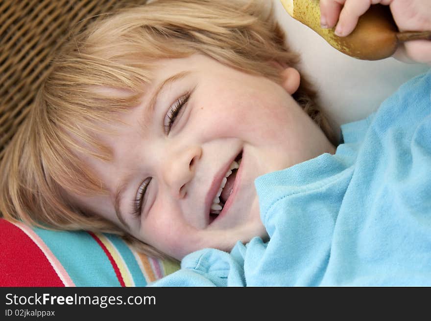 Little boy holding a pear