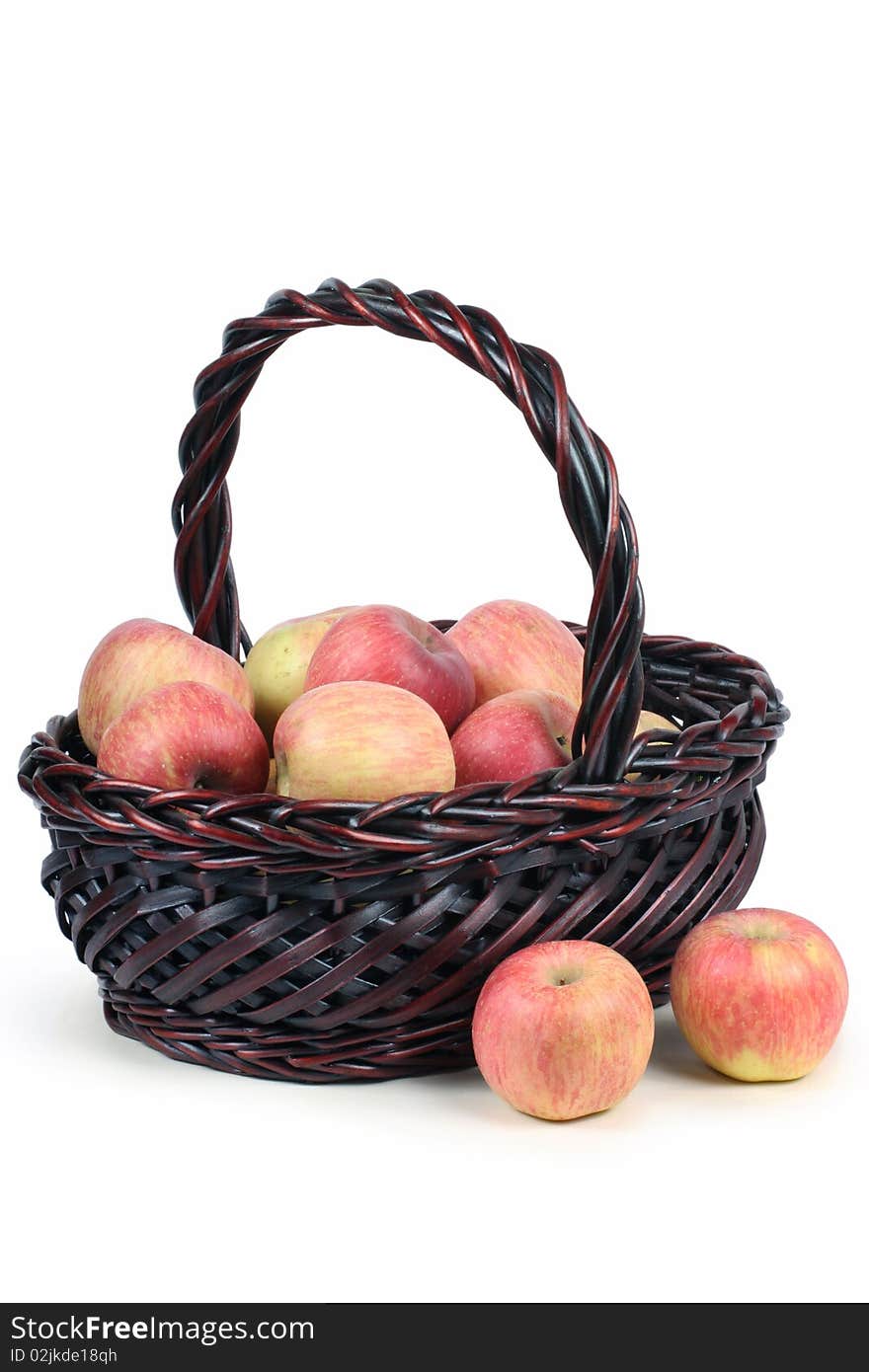 A basket with red ripe apples on white