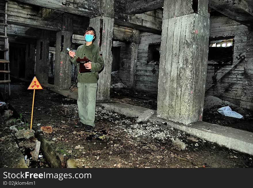 Teenager weared American military uniform.Lost city. Near Chernobyl area. Modern ruins. Ukraine. Kiev region. Teenager weared American military uniform.Lost city. Near Chernobyl area. Modern ruins. Ukraine. Kiev region