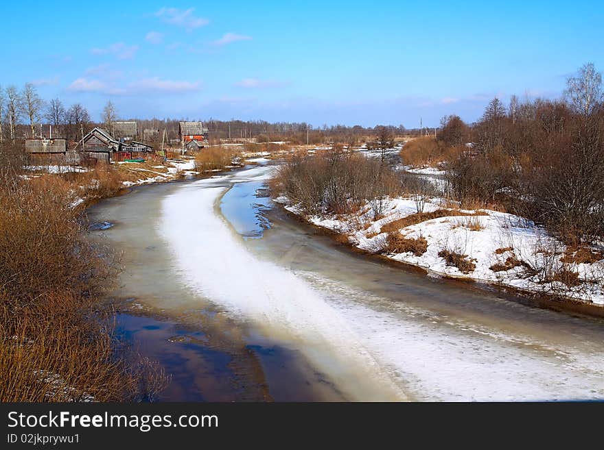 Village on spring coast river